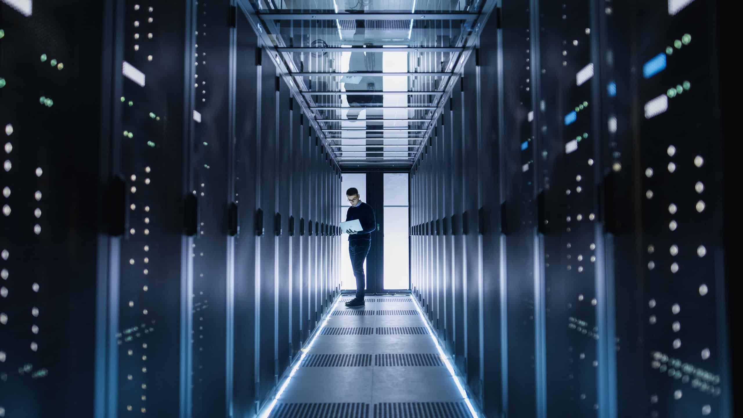 person in data center hallway